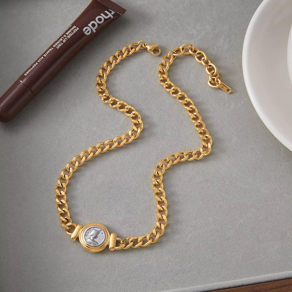 Gold curb chain necklace with vintage coin charm detail