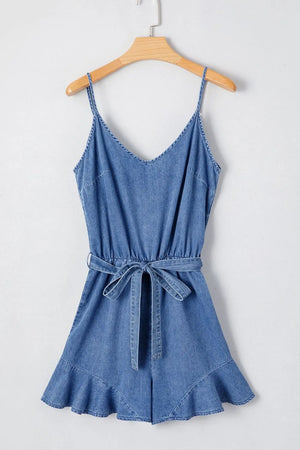 Medium denim romper with spaghetti straps, tie waist, and ruffled hem.
