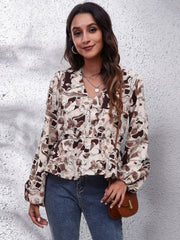 Beige peplum blouse with abstract brown print, V-neck, gathered waist, and balloon sleeves.