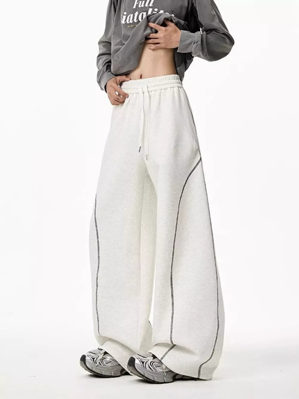 Light gray wide-leg drawstring sweatpants with contrast stitching detail.
