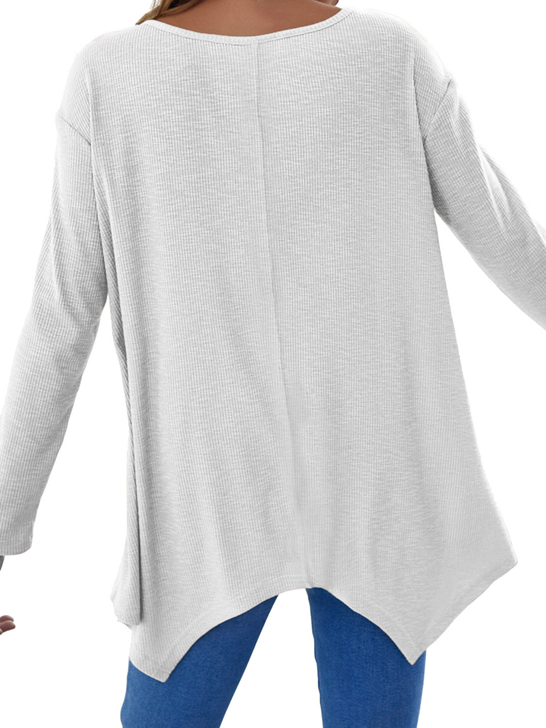 White ribbed knit tunic with long sleeves and an asymmetric hem
