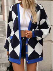 Argyle knit oversized cardigan with pockets in navy and white with blue trim.