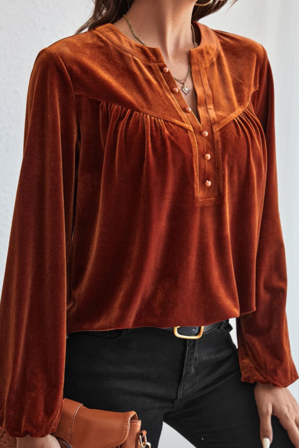 Brown velvet henley blouse with gathered detail and button placket.