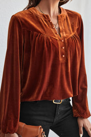 Brown velvet henley blouse with gathered detail and button placket.
