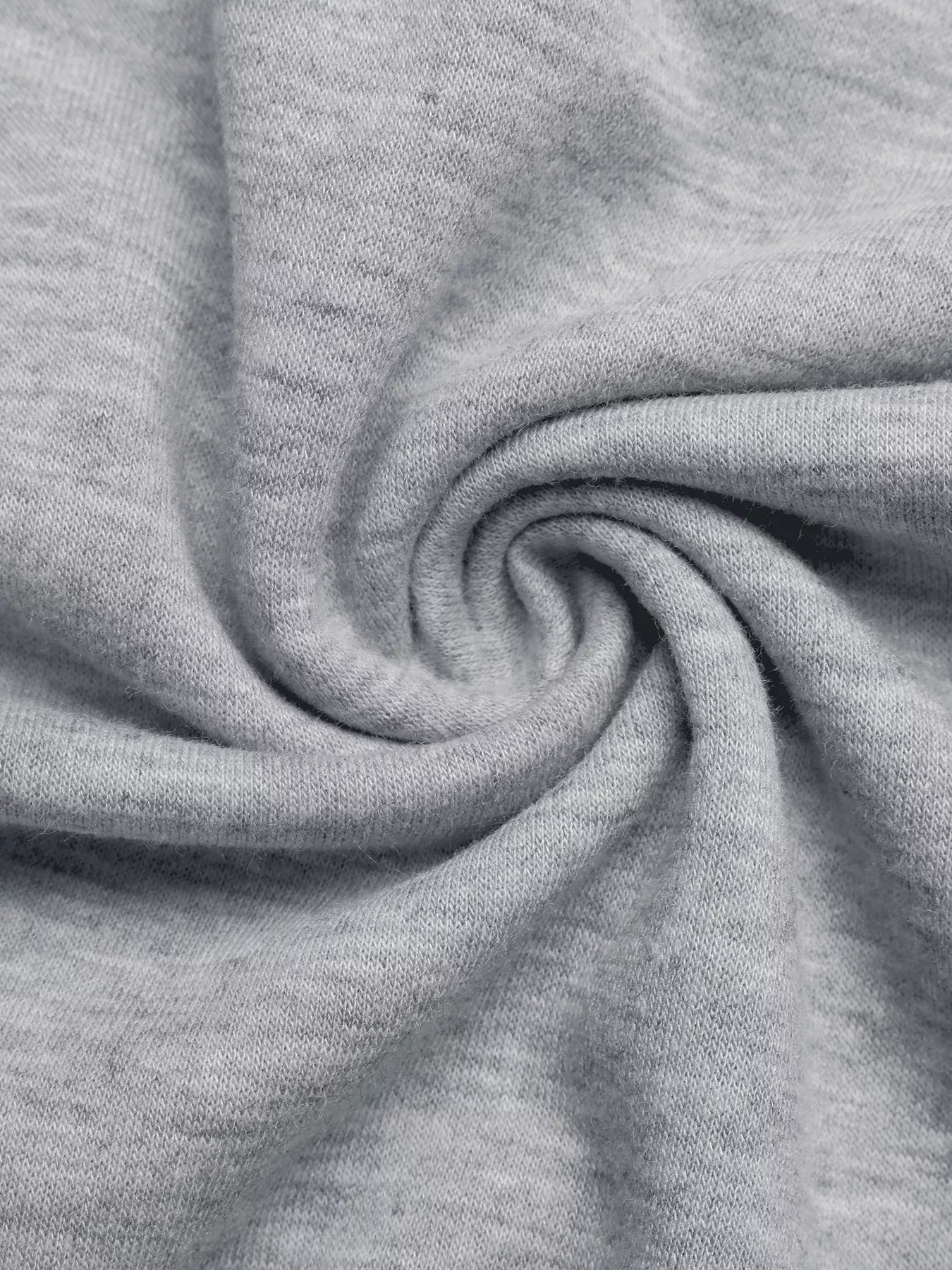 Gray boat neck sweater fabric detail, showing soft knit texture.