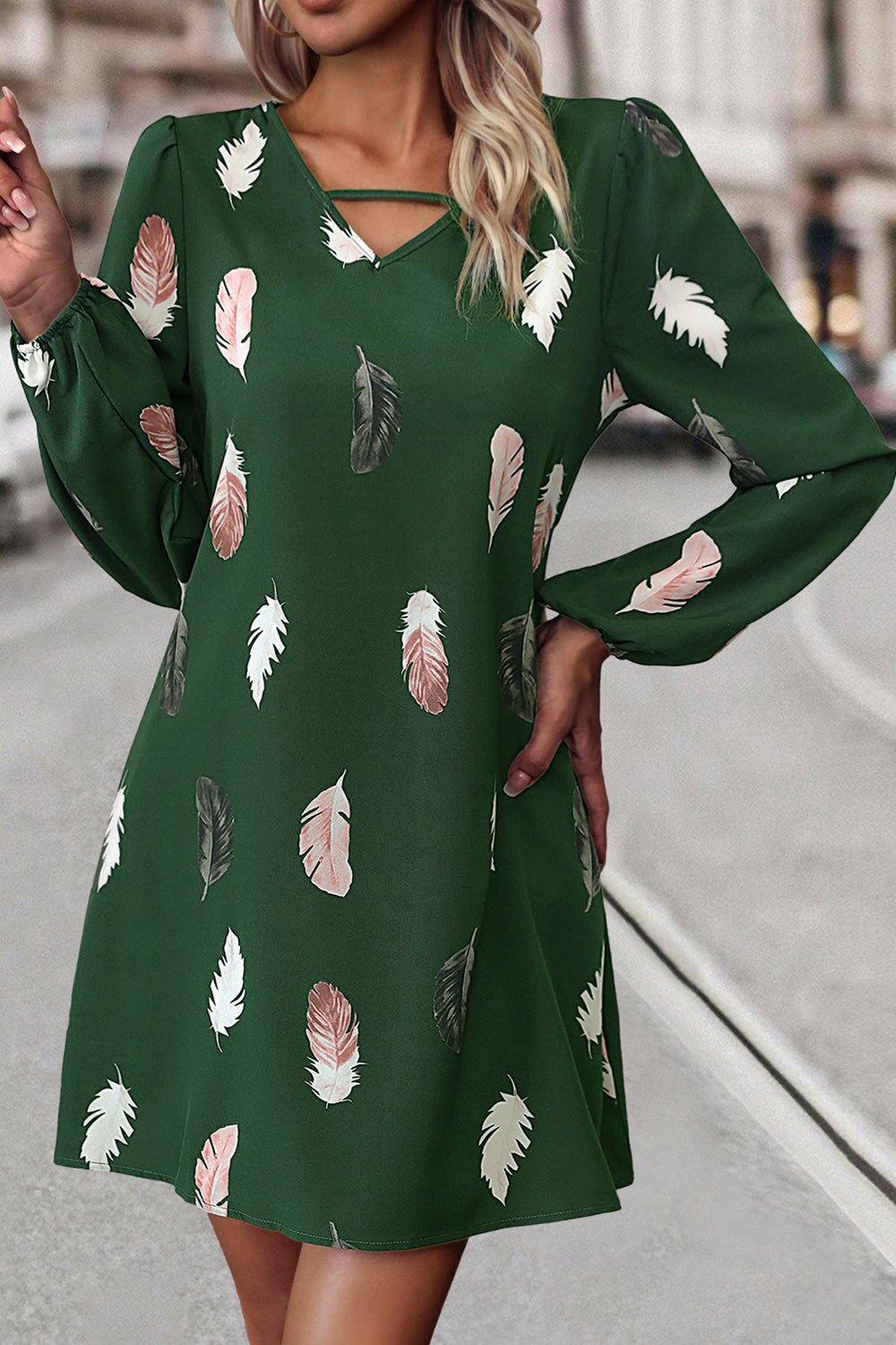 Green feather print mini dress with cutout neckline and long sleeves