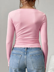 Pink ribbed square neck henley top with long sleeves, styled with jeans.