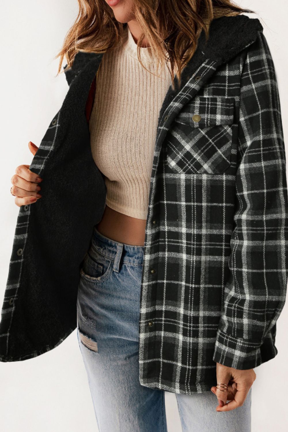 Sherpa-lined plaid overshirt jacket in black and white with button front and chest pockets.