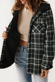 Sherpa-lined plaid overshirt jacket in black and white with button front and chest pockets.