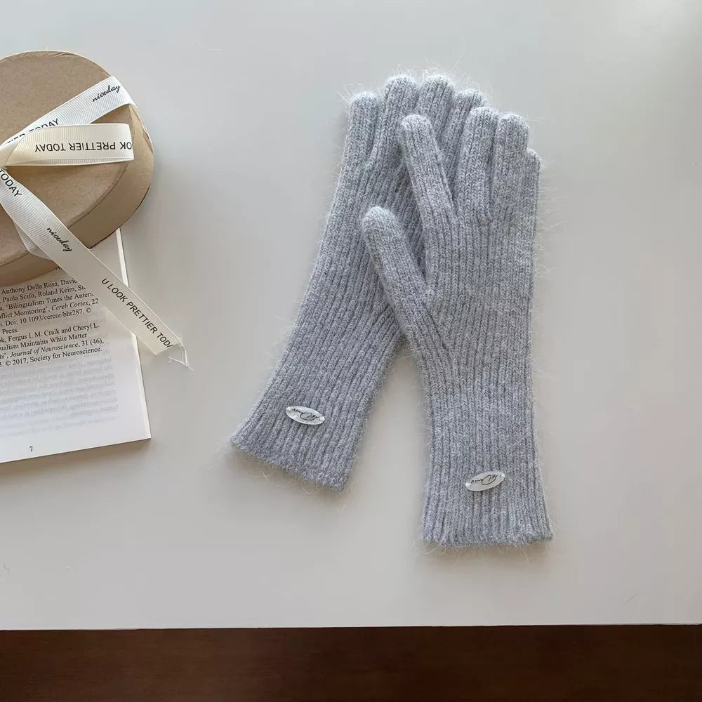 Light gray ribbed knit touchscreen gloves with fuzzy trim and oval logo detail.