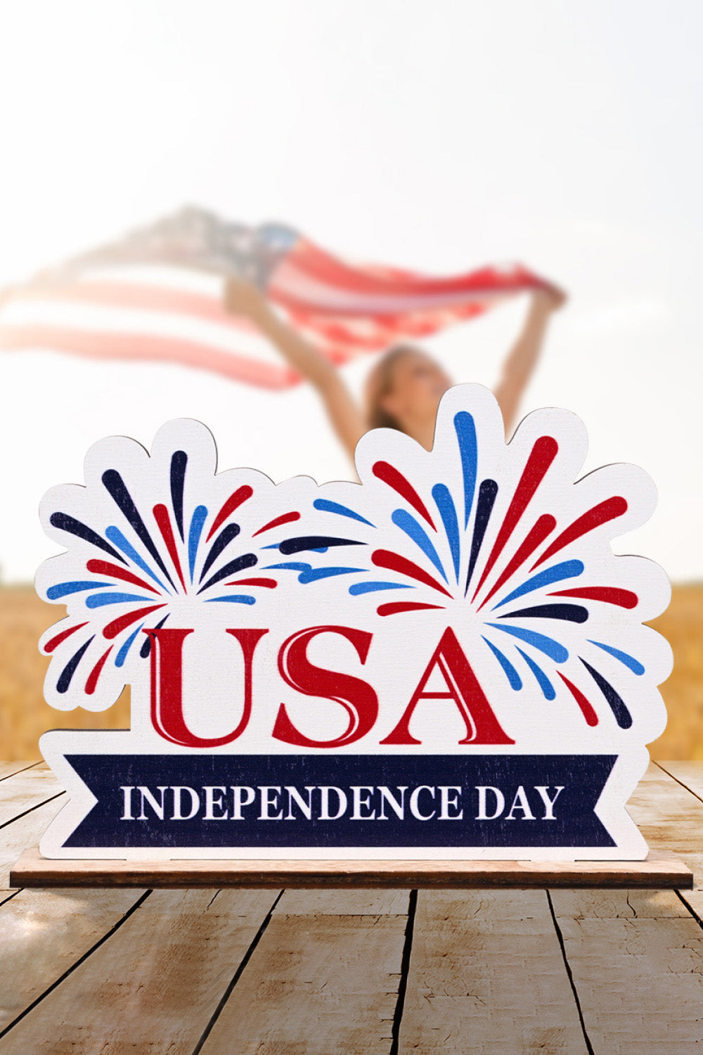 Patriotic Americana wooden tabletop decor with USA Independence Day text and fireworks design.