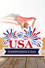 Patriotic Americana wooden tabletop decor with USA Independence Day text and fireworks design.