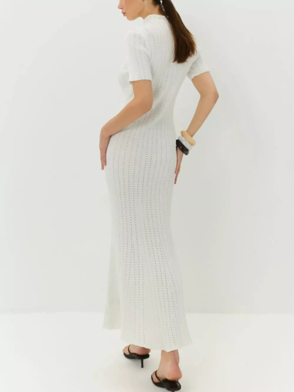 White knitted mermaid dress with short sleeves and a tied neckline, featuring a subtle open knit pattern.