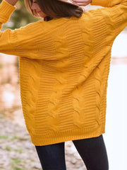 Gold cable knit duster cardigan with textured knit and long sleeves.