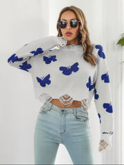 White knit cropped sweater with distressed details and blue butterfly print.