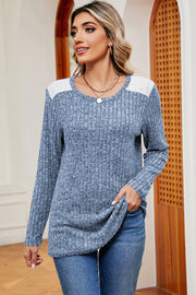 Light blue ribbed knit top with eyelet shoulder detail and crew neck.