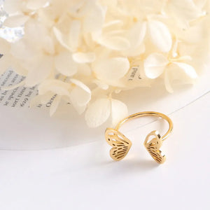Gold butterfly wing open-ended ring with intricate cutouts.