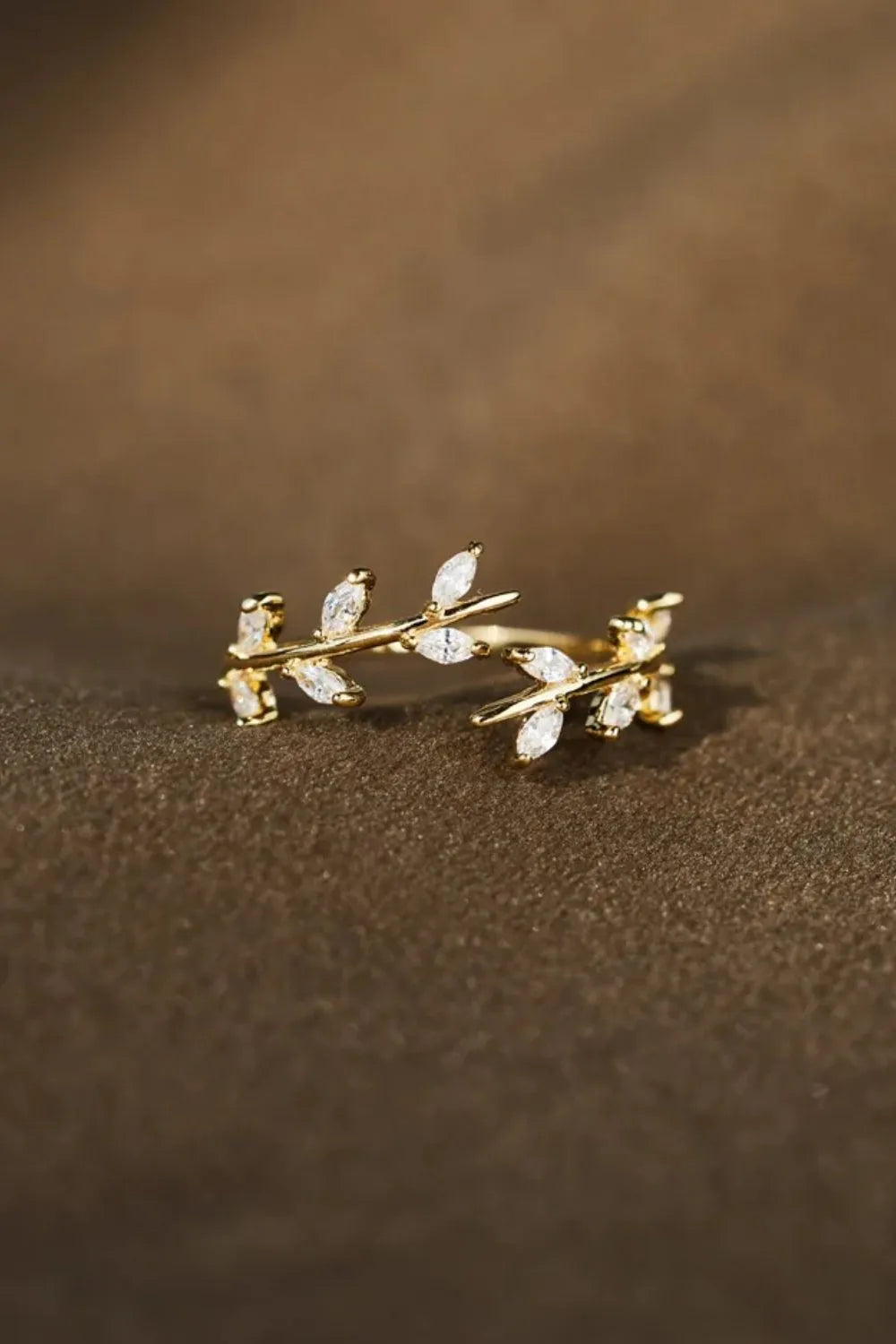 Gold open ring with branching foliage design and cubic zirconia accents