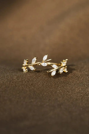 Gold open ring with branching foliage design and cubic zirconia accents