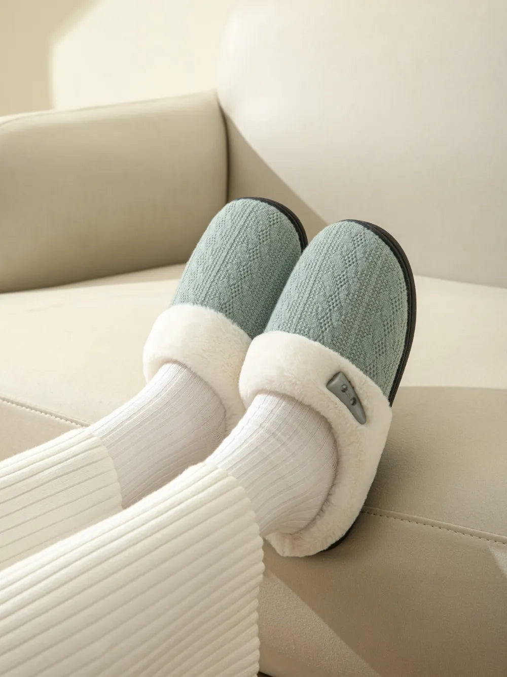 Dusty Blue cable knit shearling house slippers with white trim and button detail.