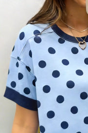 Light blue polka dot knit sweater with navy trim and crew neck.