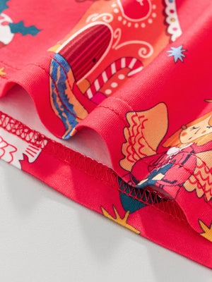 Children's red Christmas print pajama set detail, showing festive characters and stitched seams.
