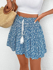 Light blue ditsy floral mini skirt with ruffled hem and drawstring waist with tassels.