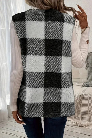 Oversized sherpa gilet in black and white buffalo check with a fuzzy texture.