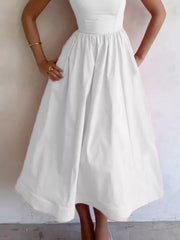 White midi dress with adjustable straps and a-line skirt, featuring a cinched waist and full skirt.
