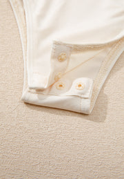 Ivory bodysuit with snap closure detail