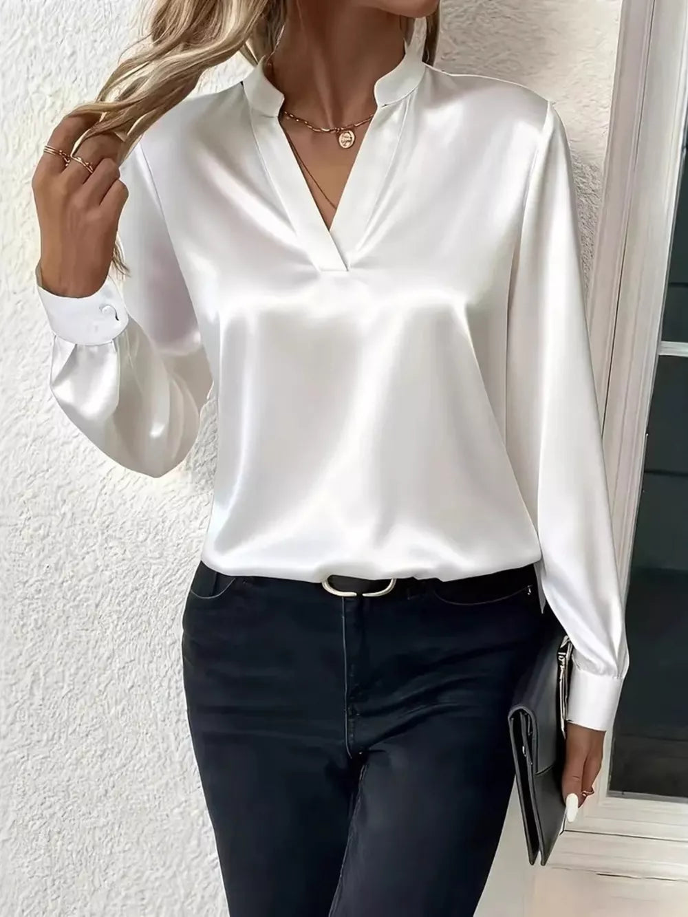 White satin maternity blouse with notched V-neck and buttoned cuffs.