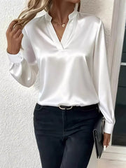 White satin maternity blouse with notched V-neck and buttoned cuffs.