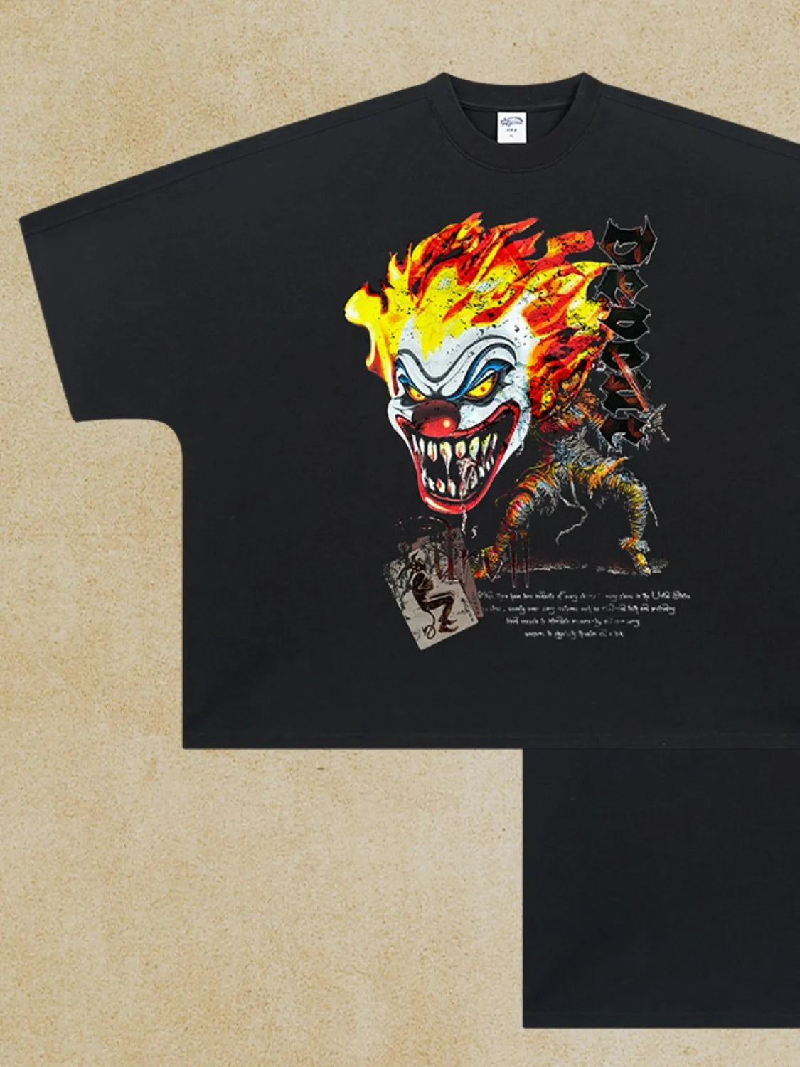 Black oversized t-shirt with a graphic of a flaming clown face and a figure.