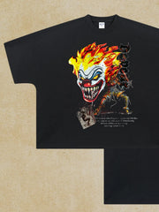 Black oversized t-shirt with a graphic of a flaming clown face and a figure.