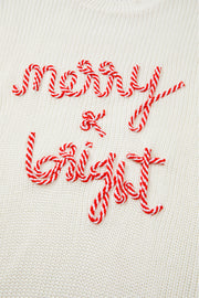 Ivory knit sweater with red and white candy cane script embroidery that reads Merry & Bright.
