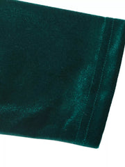Green velvet maxi dress detail showing stitching and fabric texture.