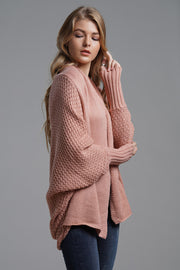 Pale Blush acrylic cocoon knit sleeve cardigan with textured knit and wide bell sleeves.