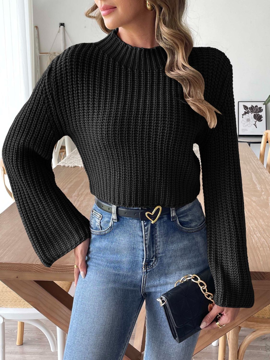 Black ribbed crop sweater with mock neck and bell sleeves.