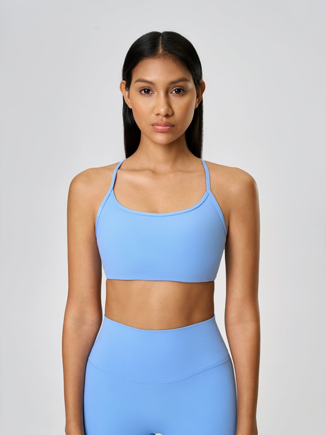 Strappy back active crop top in pastel blue with a scoop neckline.