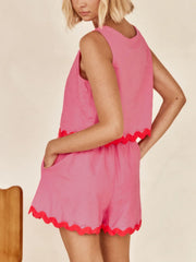 Scalloped edge tank and shorts set in fuchsia pink with contrasting red trim.
