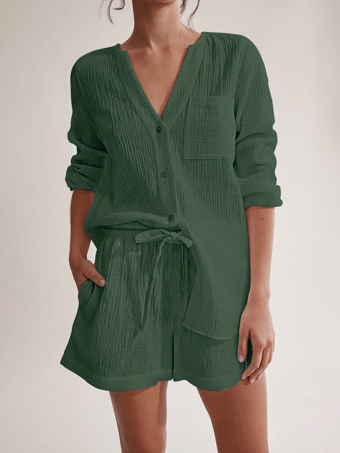 Textured cotton pajama set in dark green with button-up top and drawstring shorts.