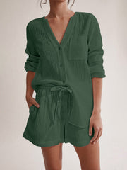 Textured cotton pajama set in dark green with button-up top and drawstring shorts.