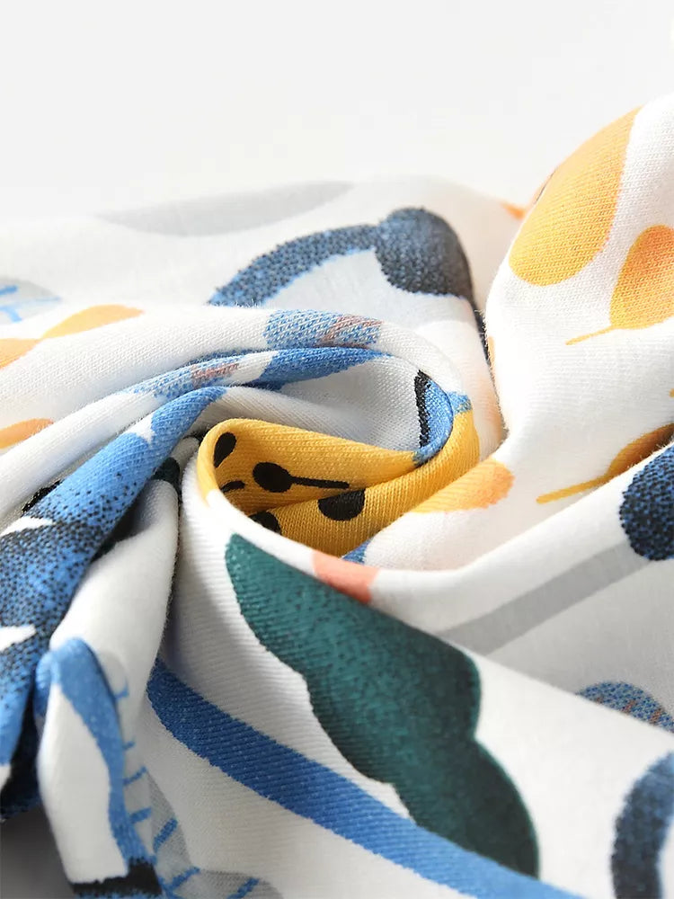 Toddler pants with whimsical floral print in cotton, featuring yellow, blue, and green abstract shapes.