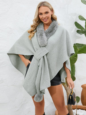 Gray faux fur collar wrap poncho with tie detail and pom-pom accent.