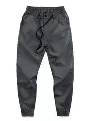 Men's grey drawstring joggers with a relaxed fit and cuffed ankles.
