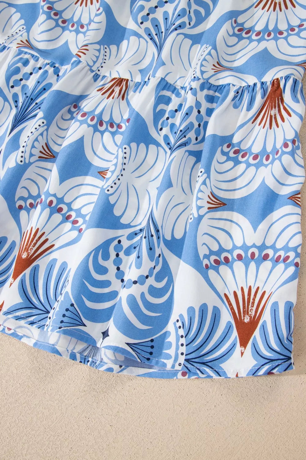 Botanic print ruffled dress with flutter sleeves and tiered hem in blue and white.