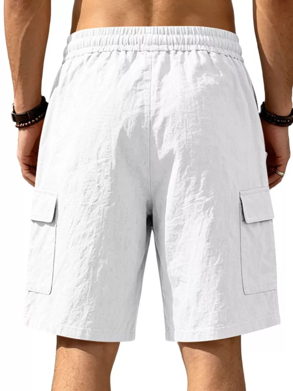 White crinkled texture cargo shorts with drawstring waist and flap pockets.