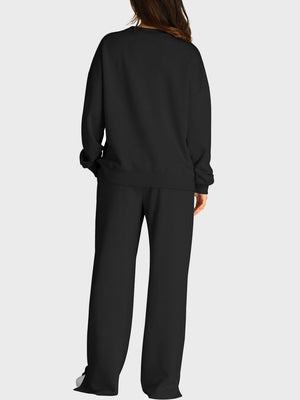 Black loungewear set with crewneck sweatshirt and wide-leg trousers with slit front detail.