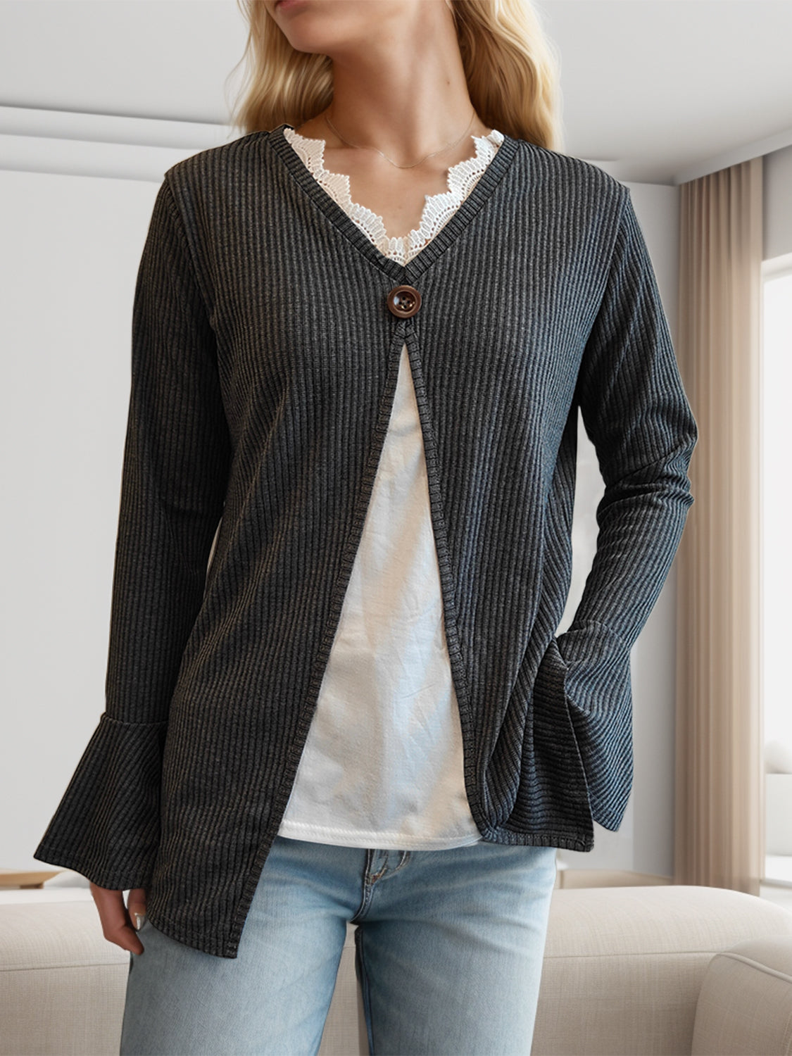 Dark gray ribbed knit layered top with bell sleeves and decorative button, styled with white lace trim.