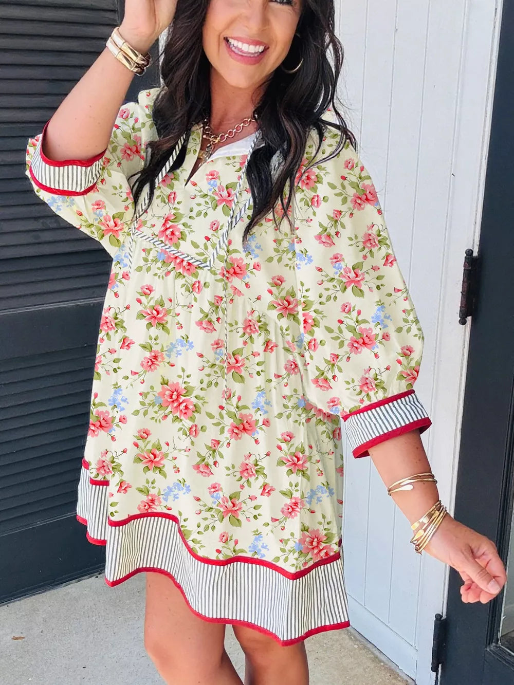 Floral puff sleeve dress with white collar, red trim, and striped hem.